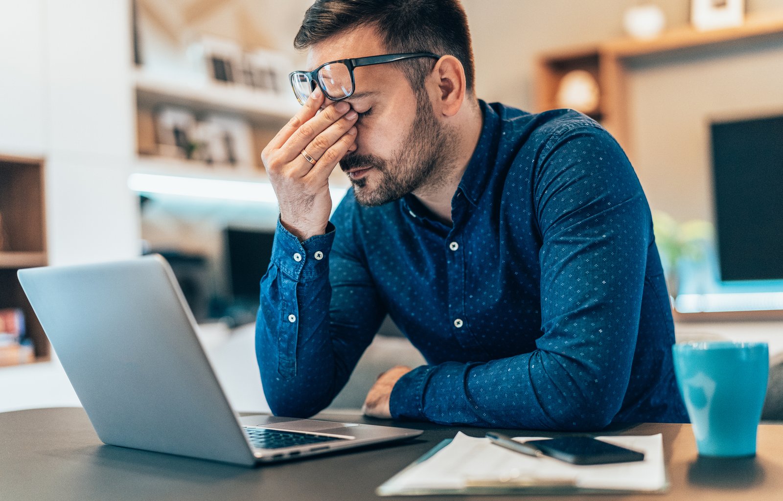 Frustrated business owner looking at shrinking website clicks on a laptop