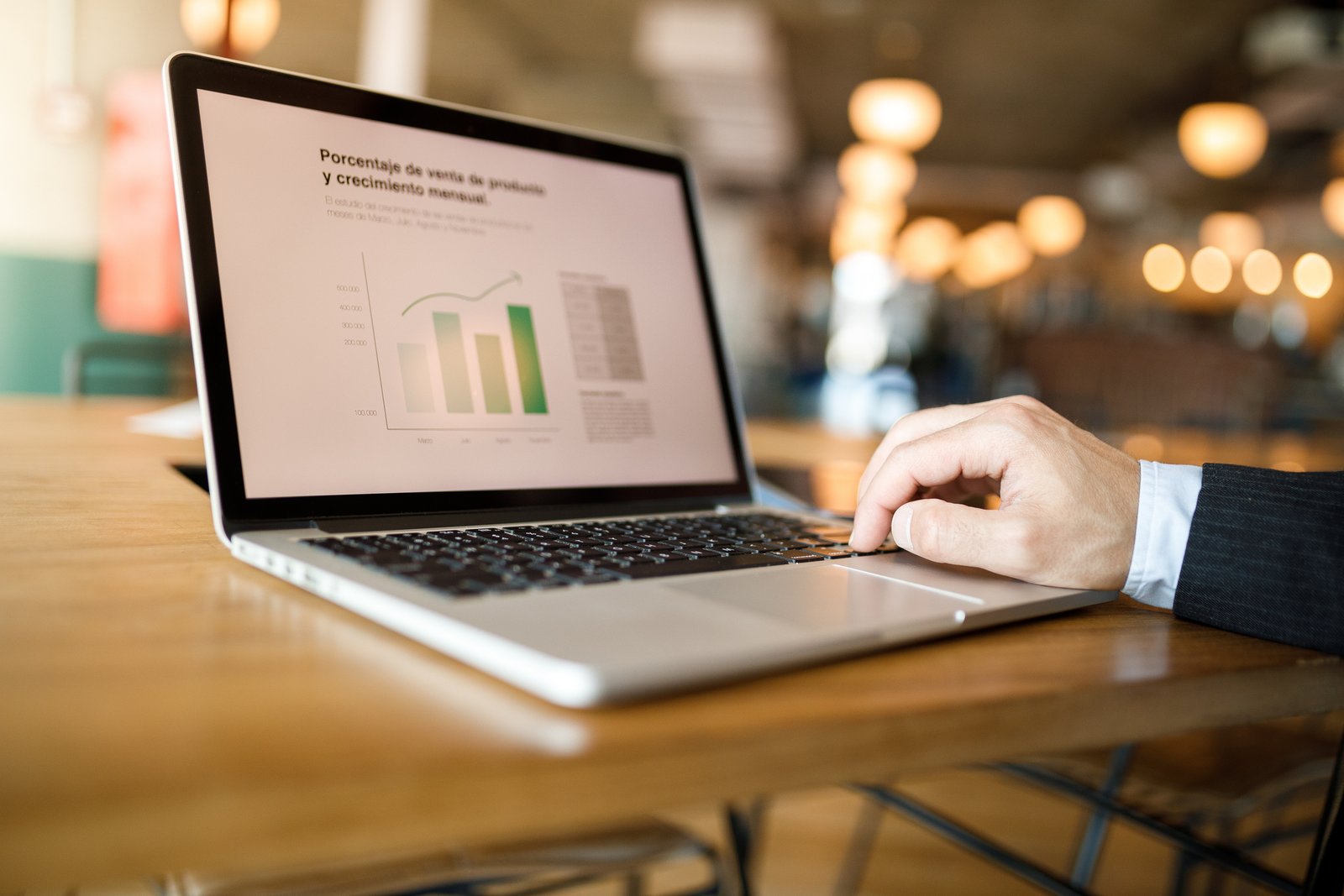 Laptop displaying a sales performance dashboard with bar charts